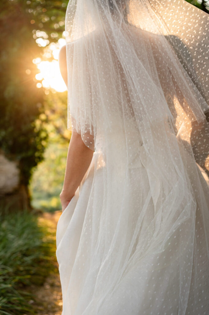 Detailed shot of the bride's veil blowing in the wind.