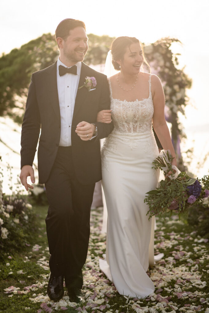 Bridal party walking down the aisle in coordinated outfits.