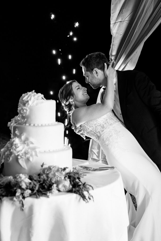 Bride and groom dancing under a canopy of lights.