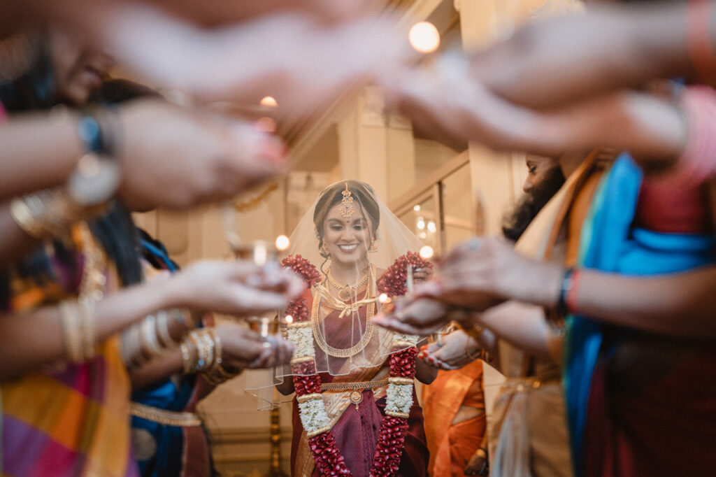 Bride holding the groom's face, about to kiss.