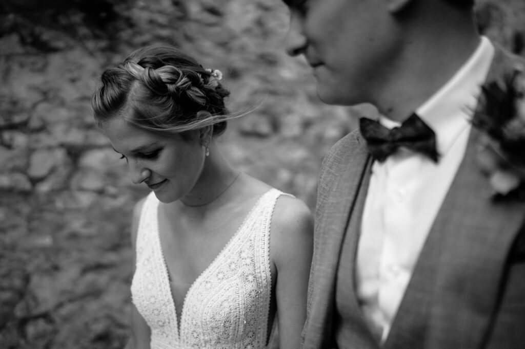 Couple sharing a kiss at the end of the aisle.