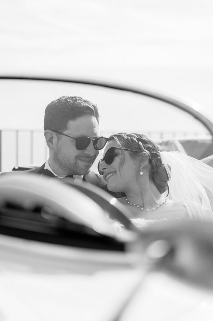 Bride and groom sharing a kiss in a flower garden.