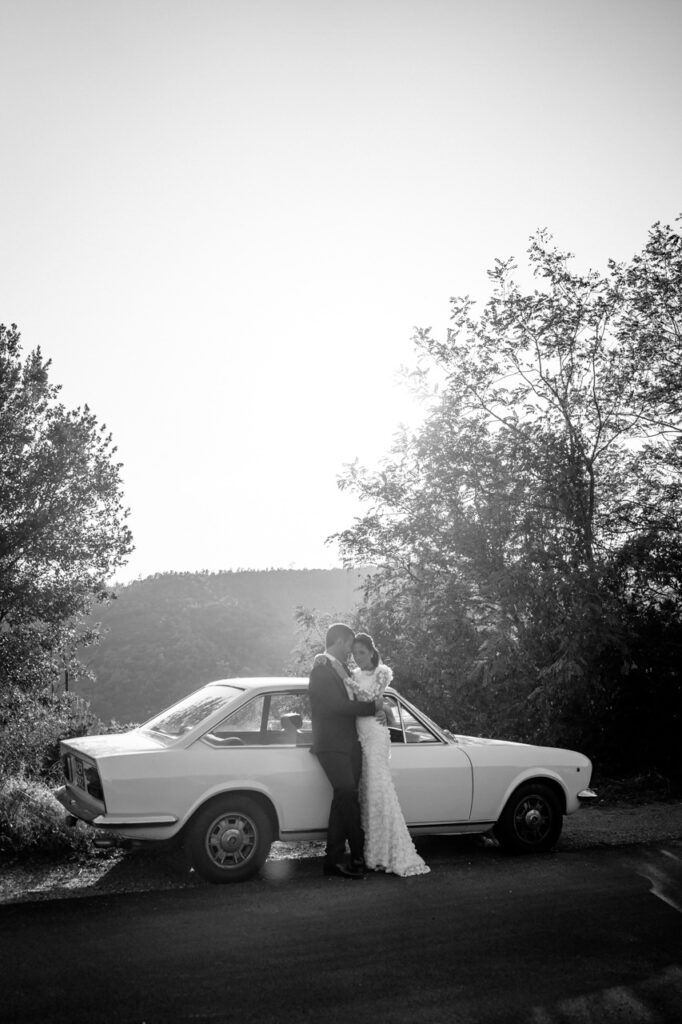 Bride and groom sharing a kiss in front of a waterfall.